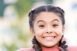 Portrait of Young Girl Smiling Showing Healthy Gums & Teeth - The Super Dentists