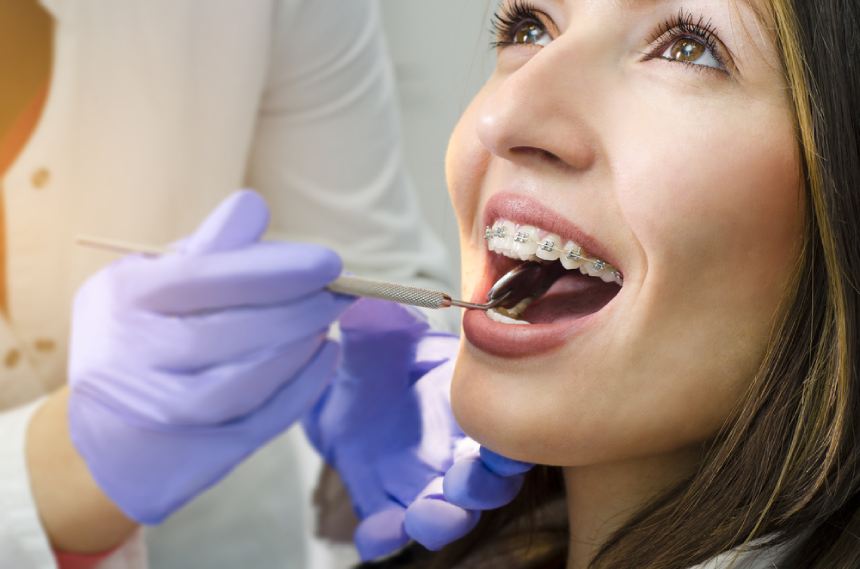 Women with braces in dentist chair