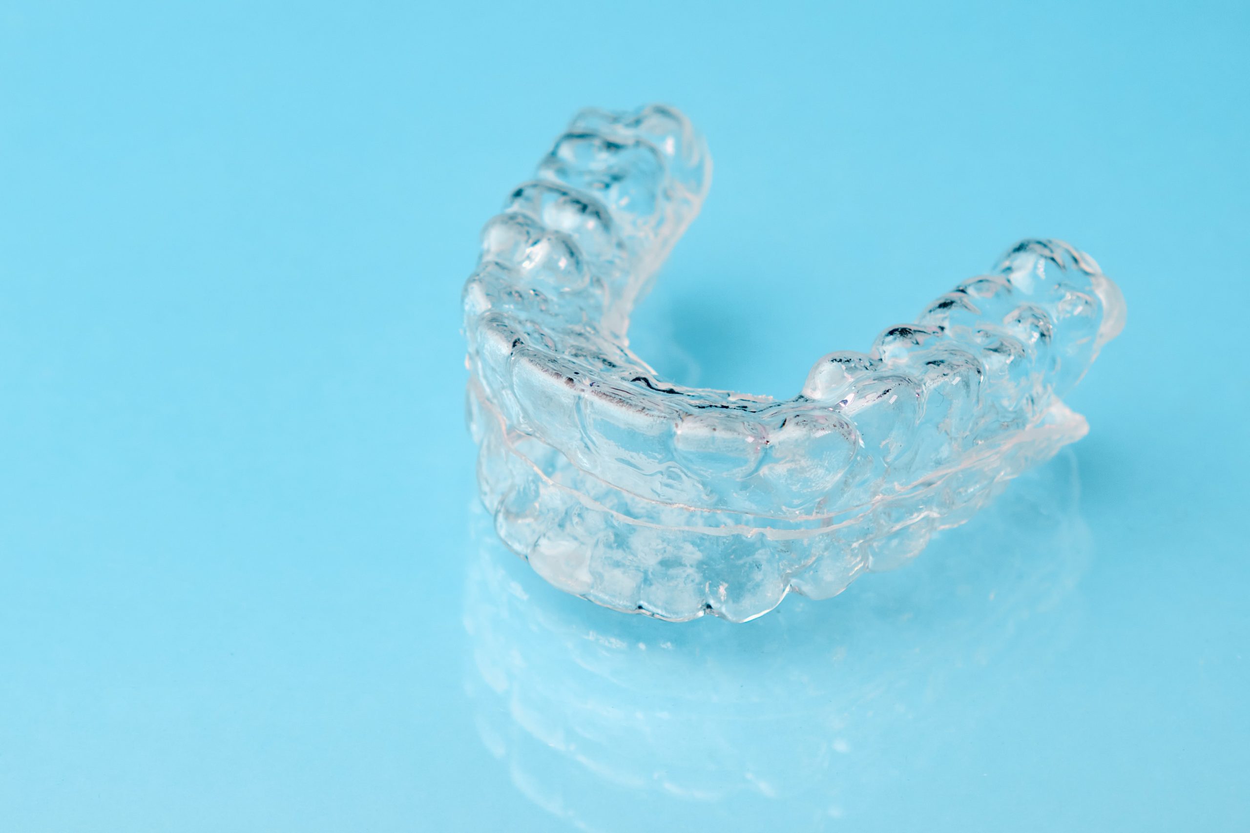 Clear Aligner on Blue Dental Countertop - The Super Dentists