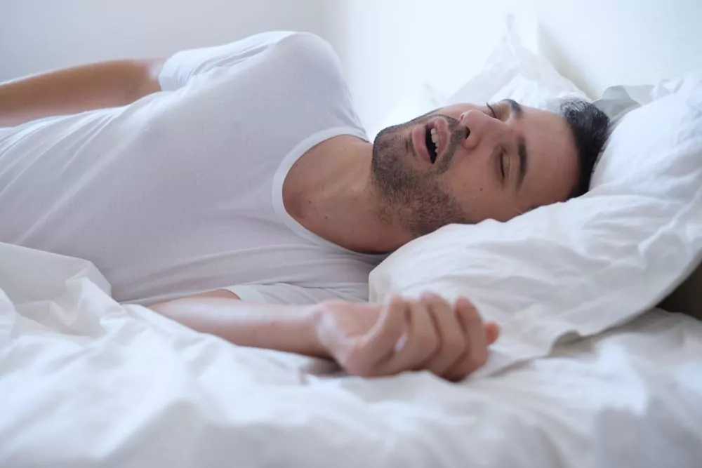 Man Sleeping in Bed with Mouth Open - The Super Dentists