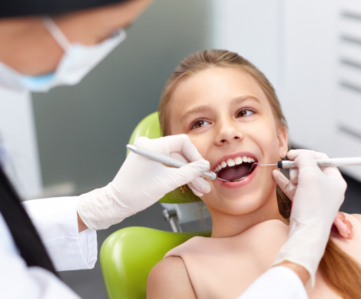 Close up of child during a dental exam - The Super Dentists