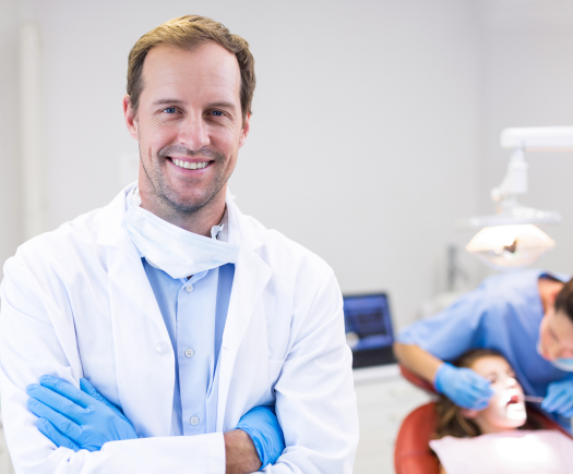 Pediatric Dentist standing in front of a patient - The Super Dentists