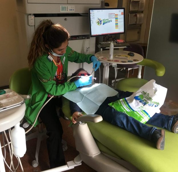 Dental Staff, providing care to child. 
