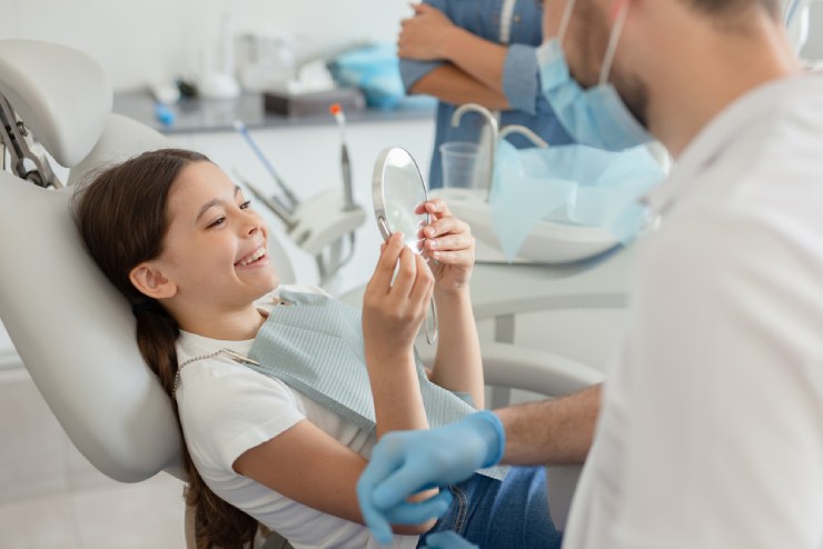 Happy girl in dentist chair