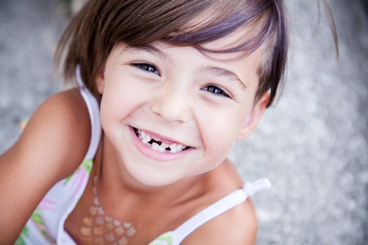 Little girl with adult teeth coming in