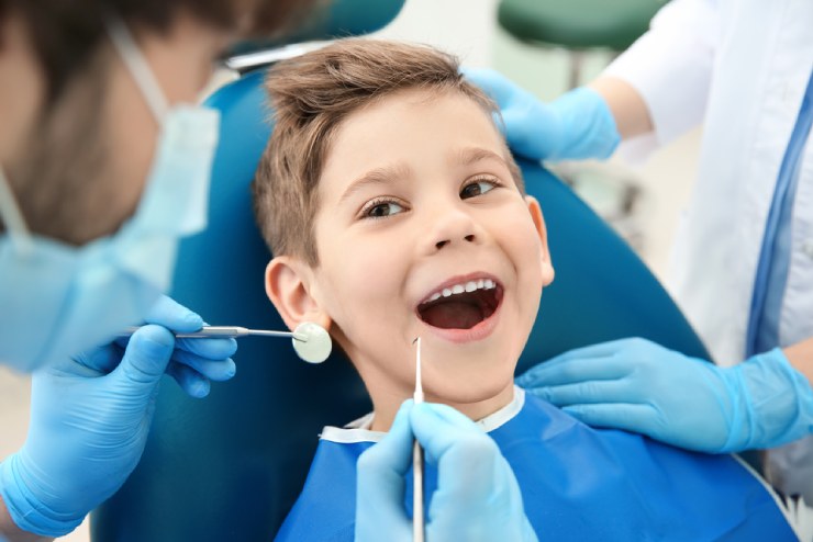 Boy at dentist getting examined