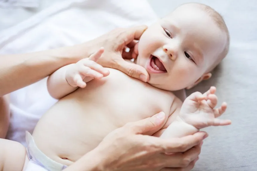 Cute baby with new teeth breaking through gums