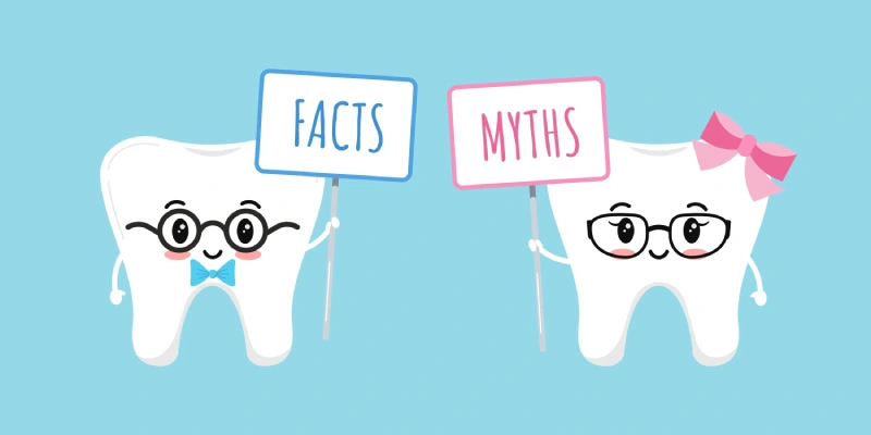 Victor of two anthropomorphized teeth holding up signs that say “dental facts” and “dental myths”