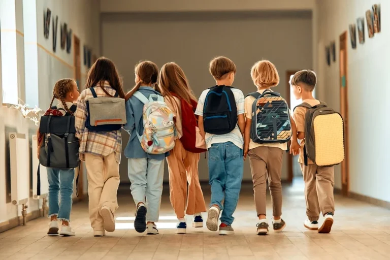 Group of young schoolchildren head back to school