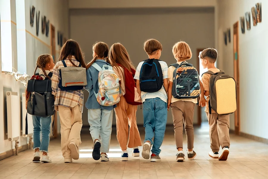 Group of young schoolchildren head back to school