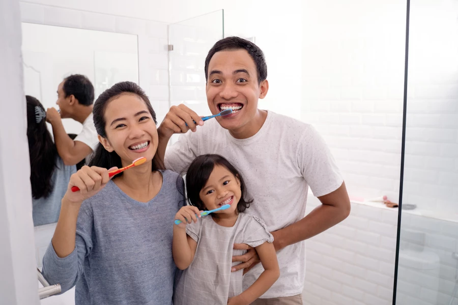 Family brushes their teeth together