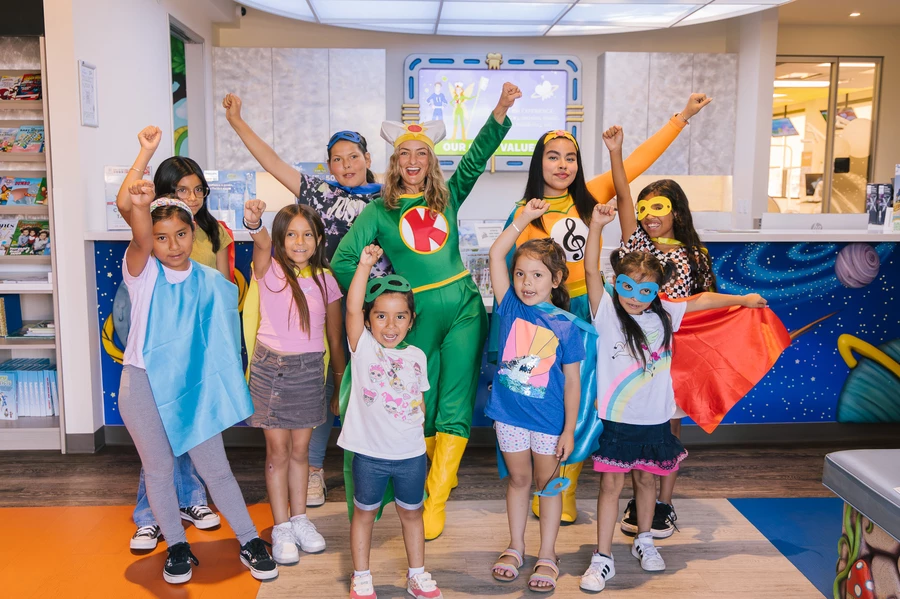 Kids posing as superheroes with Melo-D and Tooth Keri